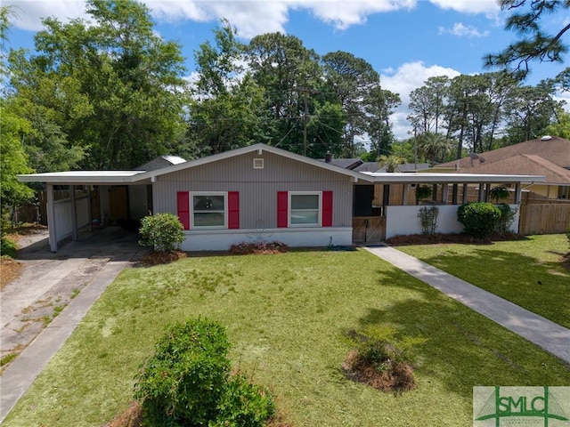 ranch-style home with concrete driveway, a front yard, fence, and a carport