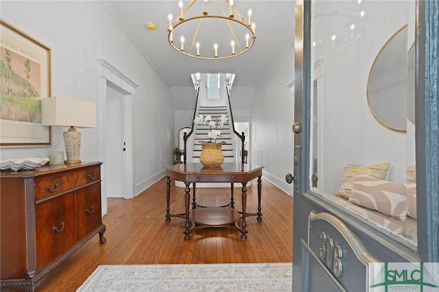 306 E Victory Dr, Savannah, GA 31405 - interior space with baseboards, wood finished floors, an inviting chandelier, and stairway