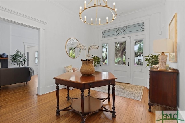 306 E Victory Dr, Savannah, GA 31405 - foyer with wood-type flooring, an inviting chandelier, crown molding, and baseboards