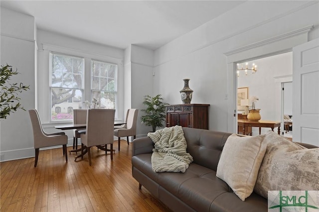 306 E Victory Dr, Savannah, GA 31405 - living room with hardwood / wood-style flooring, baseboards, and a chandelier