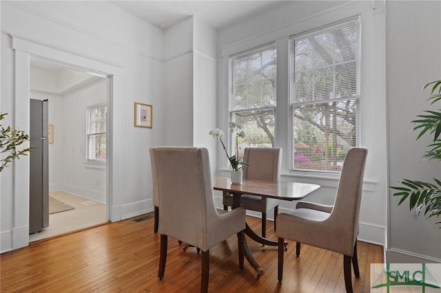 306 E Victory Dr, Savannah, GA 31405 - dining area with baseboards, light wood-style flooring, and visible vents