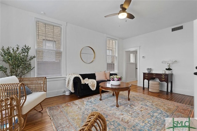 306 E Victory Dr, Savannah, GA 31405 - living area featuring wood finished floors, visible vents, baseboards, and ceiling fan