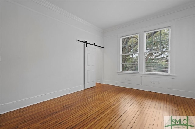 306 E Victory Dr, Savannah, GA 31405 - unfurnished room with a barn door, ornamental molding, and wood-type flooring