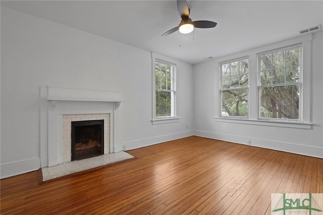 306 E Victory Dr, Savannah, GA 31405 - unfurnished living room with hardwood / wood-style floors, ceiling fan, a fireplace, baseboards, and visible vents