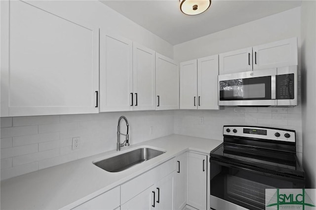 306 E Victory Dr, Savannah, GA 31405 - kitchen with light countertops, white cabinetry, stainless steel appliances, and a sink