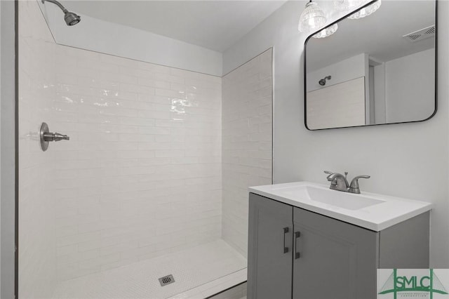 306 E Victory Dr, Savannah, GA 31405 - bathroom featuring visible vents, vanity, and a tile shower