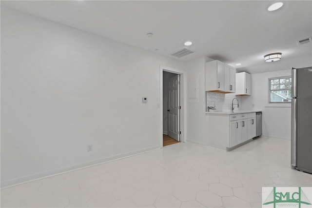 306 E Victory Dr, Savannah, GA 31405 - kitchen with white cabinets, stainless steel appliances, visible vents, and light countertops