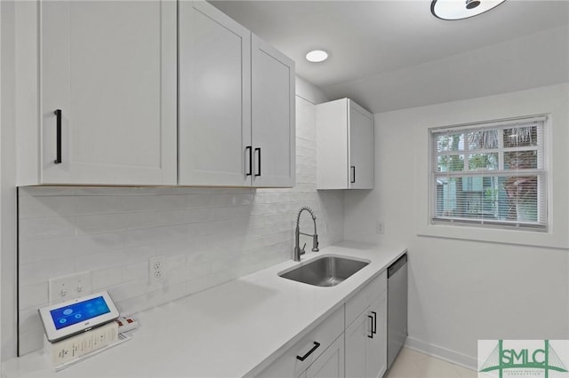 306 E Victory Dr, Savannah, GA 31405 - kitchen with light countertops, a sink, baseboards, decorative backsplash, and dishwasher