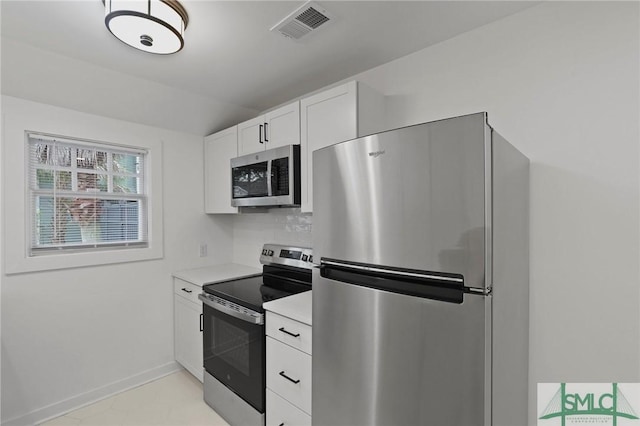 306 E Victory Dr, Savannah, GA 31405 - kitchen with white cabinets, baseboards, visible vents, light countertops, and appliances with stainless steel finishes
