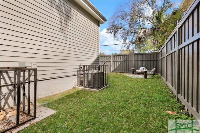 306 E Victory Dr, Savannah, GA 31405 - view of yard featuring central air condition unit and a fenced backyard