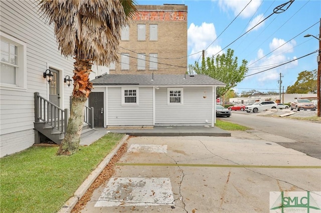 306 E Victory Dr, Savannah, GA 31405 - rear view of property with entry steps, roof with shingles, and concrete driveway