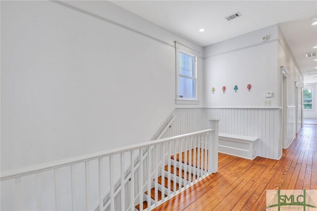 420 E Bolton St, Savannah, GA 31401 - hallway with hardwood / wood-style floors, visible vents, an upstairs landing, and a wainscoted wall