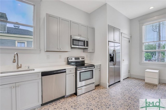 420 E Bolton St, Savannah, GA 31401 - kitchen featuring baseboards, light countertops, gray cabinetry, stainless steel appliances, and a sink