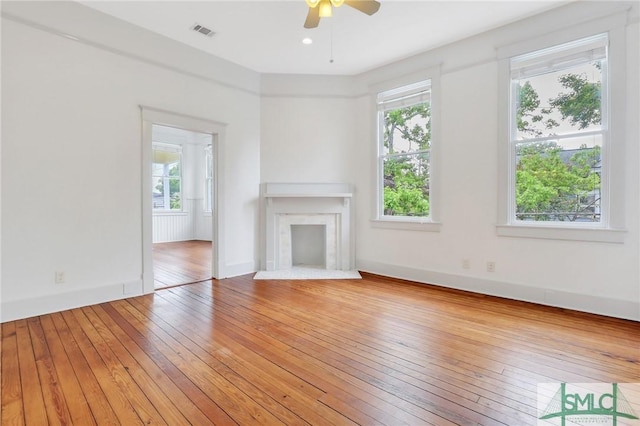420 E Bolton St, Savannah, GA 31401 - unfurnished living room with visible vents, baseboards, ceiling fan, light wood-style floors, and a fireplace