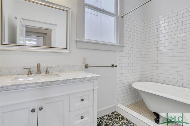 420 E Bolton St, Savannah, GA 31401 - bathroom featuring tile patterned flooring, tile walls, a freestanding tub, and vanity