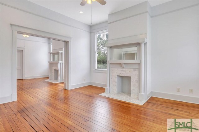 420 E Bolton St, Savannah, GA 31401 - unfurnished living room with ceiling fan, light wood finished floors, and a fireplace with flush hearth