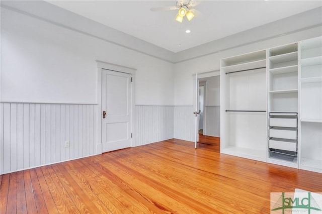 420 E Bolton St, Savannah, GA 31401 - unfurnished bedroom with light wood-type flooring, ceiling fan, and wainscoting