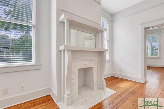 420 E Bolton St, Savannah, GA 31401 - unfurnished living room with a wealth of natural light, baseboards, and hardwood / wood-style floors
