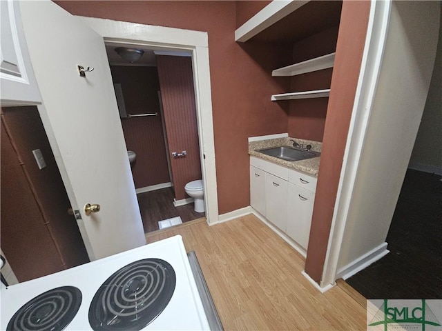 638 E 37th St, Savannah, GA 31401 - bathroom with wood finished floors, toilet, baseboards, and vanity