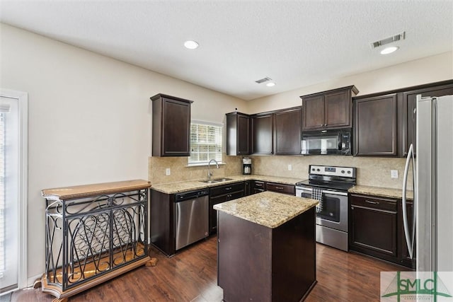646 Red Oak Ln, Hinesville, GA 31313 - kitchen with a sink, dark brown cabinets, appliances with stainless steel finishes, and dark wood finished floors