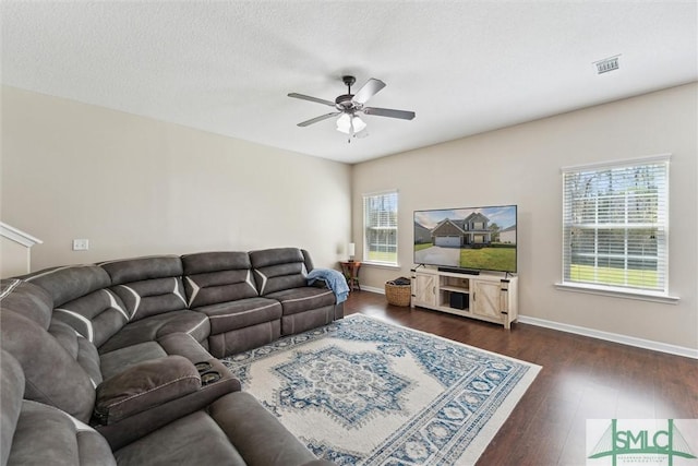 646 Red Oak Ln, Hinesville, GA 31313 - living area with dark wood-style flooring, baseboards, a textured ceiling, visible vents, and ceiling fan