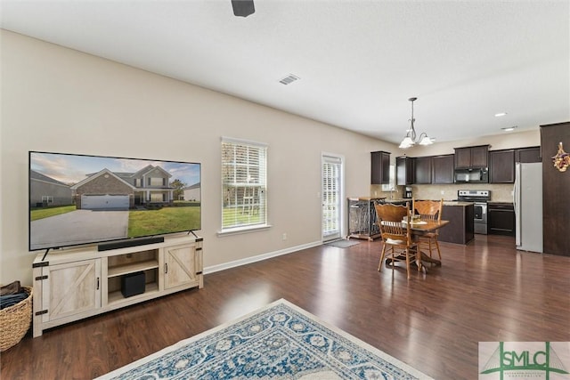 646 Red Oak Ln, Hinesville, GA 31313 - living area featuring baseboards, visible vents, a chandelier, and dark wood finished floors