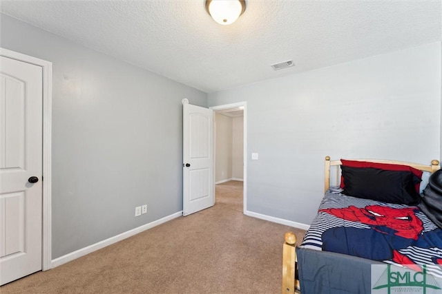 646 Red Oak Ln, Hinesville, GA 31313 - carpeted bedroom featuring baseboards, a textured ceiling, and visible vents