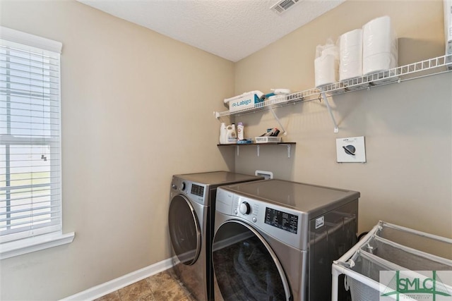 646 Red Oak Ln, Hinesville, GA 31313 - clothes washing area with a textured ceiling, visible vents, baseboards, laundry area, and separate washer and dryer