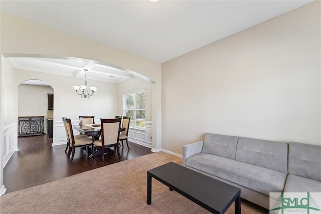 646 Red Oak Ln, Hinesville, GA 31313 - living room featuring coffered ceiling, ornamental molding, a chandelier, arched walkways, and beam ceiling