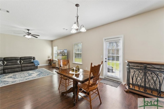 646 Red Oak Ln, Hinesville, GA 31313 - dining area with baseboards, visible vents, wood finished floors, and ceiling fan with notable chandelier
