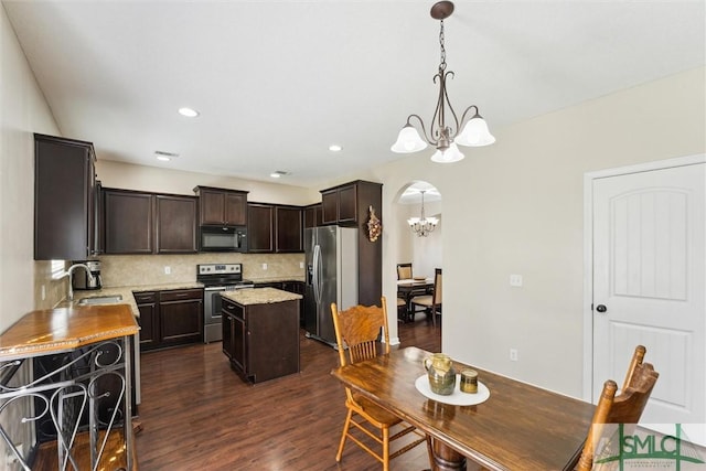 646 Red Oak Ln, Hinesville, GA 31313 - kitchen featuring a notable chandelier, dark brown cabinetry, a sink, a kitchen island, and appliances with stainless steel finishes