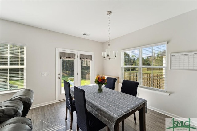 148 Spring Hill Dr, Richmond Hill, GA 31324 - dining area featuring baseboards, wood finished floors, and a chandelier