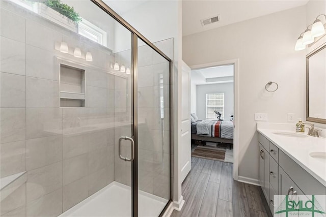 148 Spring Hill Dr, Richmond Hill, GA 31324 - ensuite bathroom with visible vents, double vanity, connected bathroom, a sink, and a stall shower