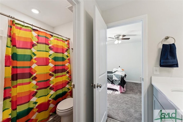 148 Spring Hill Dr, Richmond Hill, GA 31324 - full bath with toilet, curtained shower, vanity, a ceiling fan, and visible vents