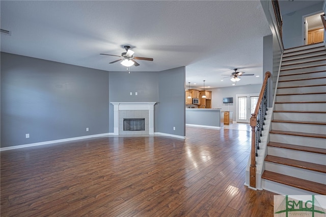 402 Walthour Dr, Rincon, GA 31326 - unfurnished living room with ceiling fan, stairway, dark wood finished floors, and baseboards