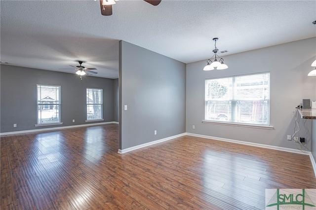 402 Walthour Dr, Rincon, GA 31326 - empty room with ceiling fan, wood finished floors, baseboards, a textured ceiling, and a chandelier