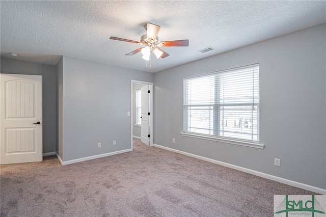 402 Walthour Dr, Rincon, GA 31326 - unfurnished bedroom featuring carpet, a textured ceiling, baseboards, and ceiling fan