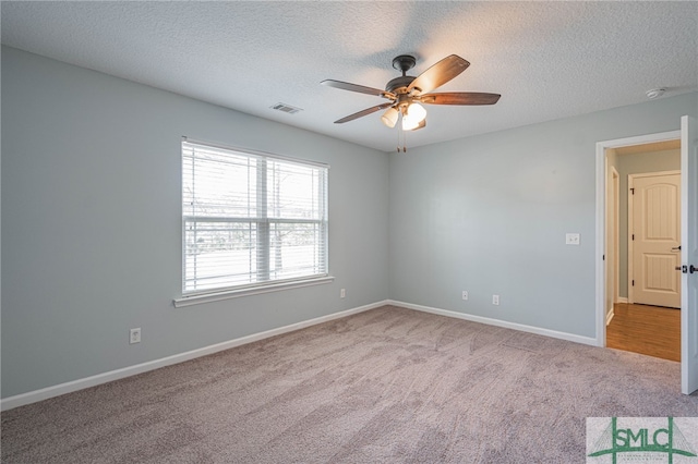 402 Walthour Dr, Rincon, GA 31326 - carpeted empty room featuring ceiling fan, a textured ceiling, and a smoke detector