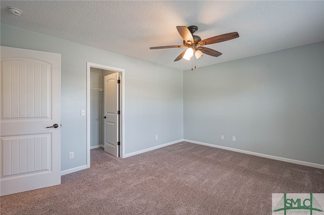402 Walthour Dr, Rincon, GA 31326 - unfurnished bedroom featuring carpet, a walk in closet, a textured ceiling, baseboards, and a ceiling fan