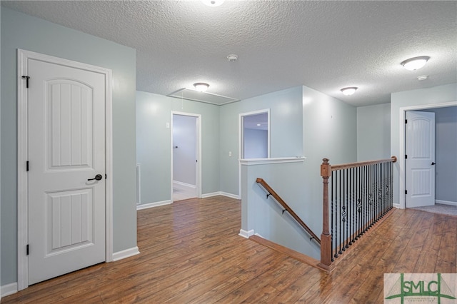 402 Walthour Dr, Rincon, GA 31326 - hall with attic access, an upstairs landing, hardwood / wood-style floors, baseboards, and a textured ceiling