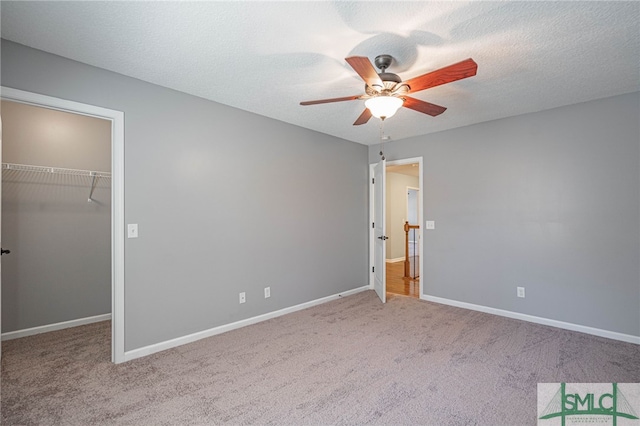 402 Walthour Dr, Rincon, GA 31326 - unfurnished bedroom with carpet flooring, a spacious closet, baseboards, and a ceiling fan