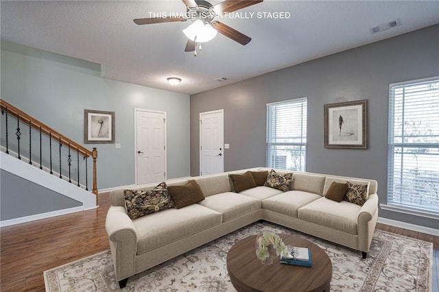402 Walthour Dr, Rincon, GA 31326 - living room featuring wood finished floors, stairs, plenty of natural light, and baseboards