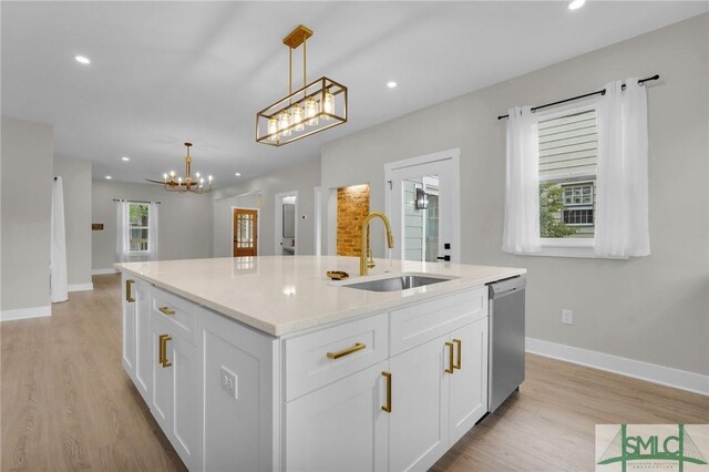 kitchen featuring a notable chandelier, light wood-style floors, a sink, and dishwasher
