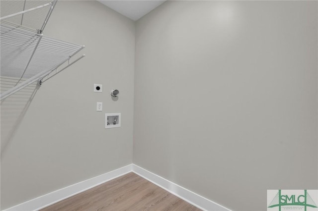 laundry area with light wood finished floors, laundry area, hookup for an electric dryer, hookup for a washing machine, and baseboards