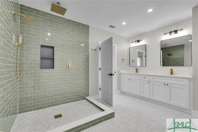 full bathroom featuring a sink, visible vents, recessed lighting, a walk in shower, and double vanity
