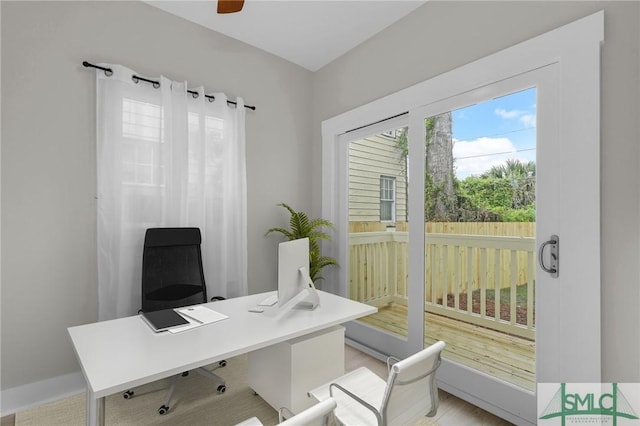 office area featuring baseboards and light wood-type flooring