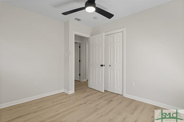 unfurnished bedroom featuring a closet, baseboards, visible vents, light wood-style floors, and ceiling fan