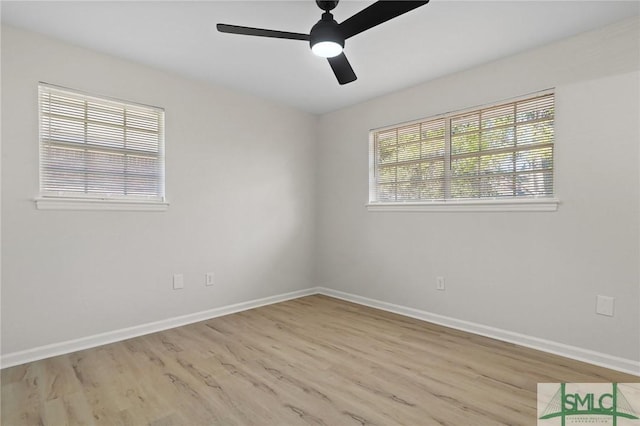 spare room with wood finished floors, baseboards, and ceiling fan