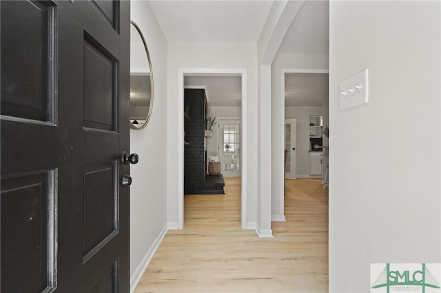 entryway with baseboards and light wood-type flooring