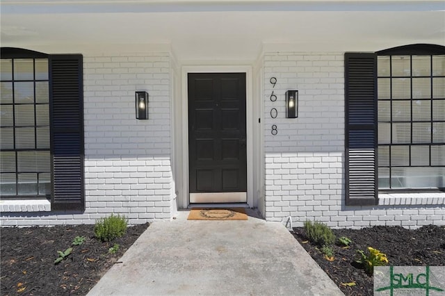 entrance to property with brick siding